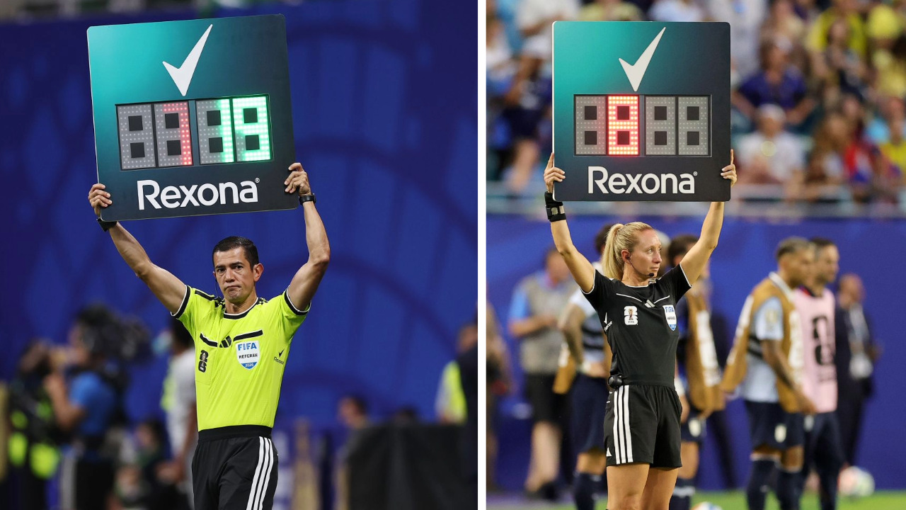Two FIFA referees raising the substitution board, with the Rexona logo printed at the bottom of the board