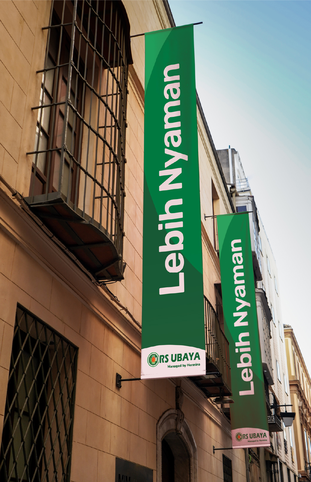 RS Ubaya banner signage reading 'Lebih Nyaman' on a hospital exterior